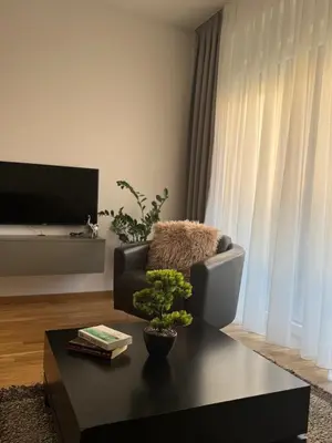 a living room with a chair and a coffee table at Urban Suite BL Apartment in Banja Luka