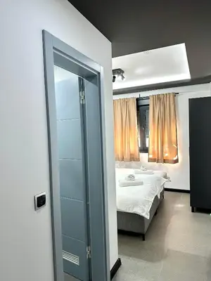 a bedroom with a bed and a glass door at Prenoćište Vozač in Jajce