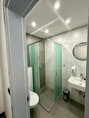a bathroom with a shower and a toilet and a sink at Prenoćište Vozač in Jajce