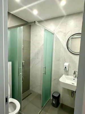 a bathroom with a shower and a toilet and a sink at Prenoćište Vozač in Jajce