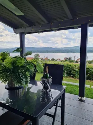a table with a bottle of wine on a patio at Vienna Rem in Lukavac