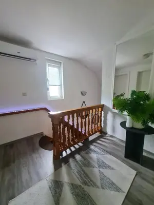 a room with a staircase and a potted plant at Vienna Rem in Lukavac