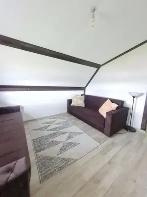 a living room with a couch and a rug at Vienna Rem in Lukavac