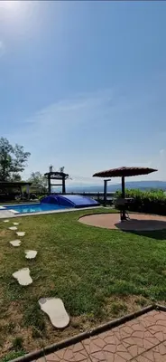 a view of a swimming pool with a picnic table and a picnic table at Vienna Rem in Lukavac