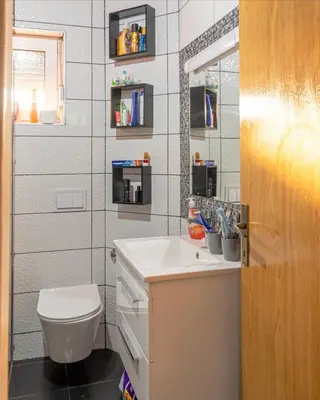 a bathroom with a white sink and a toilet at Vienna Rem in Lukavac