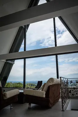 a living room with a large group of windows at Villa Gaia Novi Grad