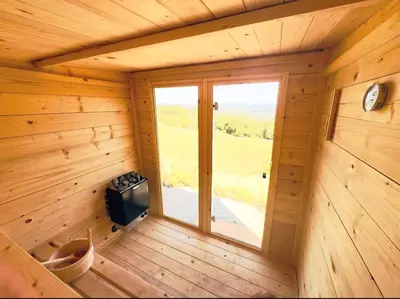 an empty room with a window in a wooden cabin at Villa Gaia Novi Grad