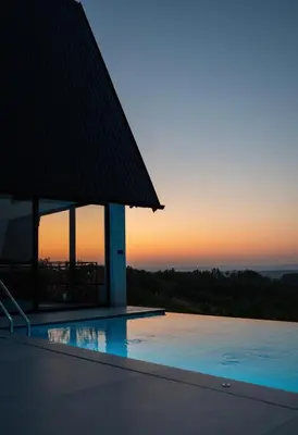 a swimming pool with a sunset in the background at Villa Gaia Novi Grad