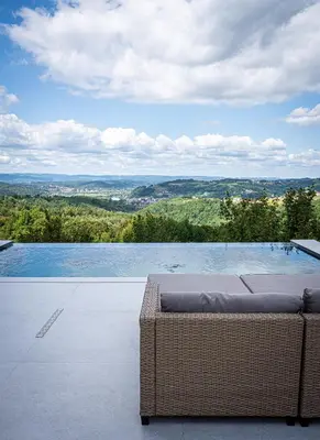 a swimming pool with a view of the mountains at Villa Gaia Novi Grad