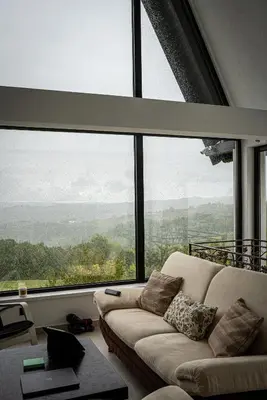 a living room with a couch in front of a large window at Villa Gaia Novi Grad