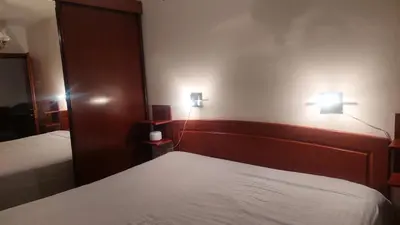 a bedroom with two beds and two lights on the wall at Lux apartman sa garažom in Banja Luka