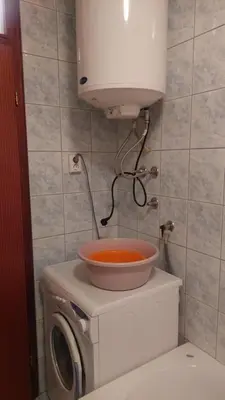 a washing machine with a bowl on top of it at Lux apartman sa garažom in Banja Luka