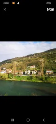 a picture of a river with houses in the background at Lux apartman sa garažom in Banja Luka