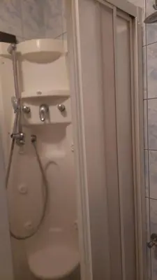a white toilet in a bathroom with a shower at Lux apartman sa garažom in Banja Luka