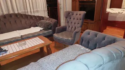 a living room with a couch and a chair at Lux apartman sa garažom in Banja Luka