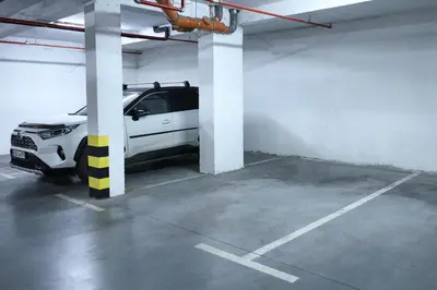 a white car parked in a parking lot at Kosta Boutique Apartment in Banja Luka