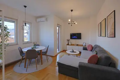 a living room with a couch and a table at Kosta Boutique Apartment in Banja Luka