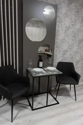 a table and two chairs with plates and wine glasses at Apartman Elite Stay Doboj in Doboj