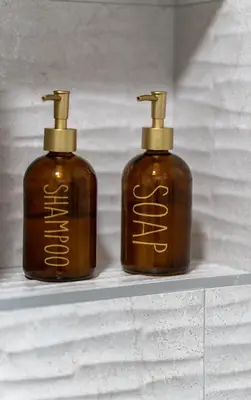 two bottles of soap sitting on a shelf at Apartman Elite Stay Doboj in Doboj