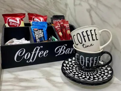 a coffee bar with two coffee cups on a plate at FILIP Lux Apartman sa garažom in Doboj