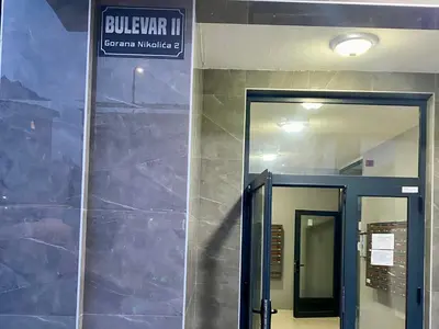 a doorway into a building with a sign on the wall at FILIP Lux Apartman sa garažom in Doboj