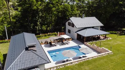 an aerial view of a house with a swimming pool at Villa Bagrem - Villa with private pool in nature in Banja Luka