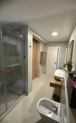 a bathroom with a glass shower and a sink at Villa Bagrem - Villa with private pool in nature in Banja Luka