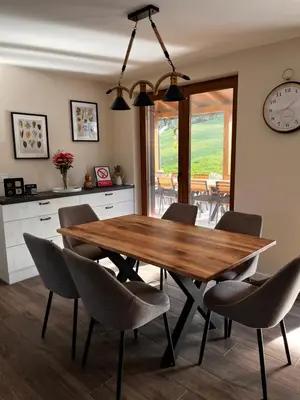 a dining room with a wooden table and chairs at Villa Bagrem - Villa with private pool in nature in Banja Luka