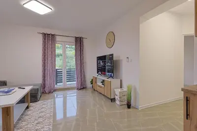 a living room with a tv and a table at NolE Apartments in Visoko