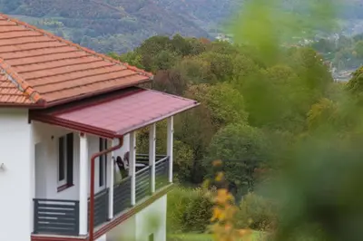 a white house with a red roof with a view at NolE Apartments in Visoko
