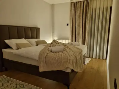 a bedroom with a bed with a blanket on it at Semic apartments in Visoko