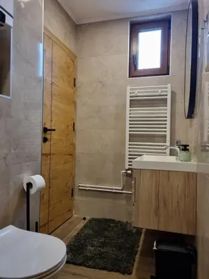 a bathroom with a toilet and a sink and a shower at Semic apartments in Visoko