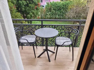 a table and four chairs sitting on a balcony at Semic apartments in Visoko