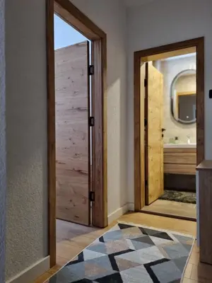 a room with a wooden door and a rug at Semic apartments in Visoko