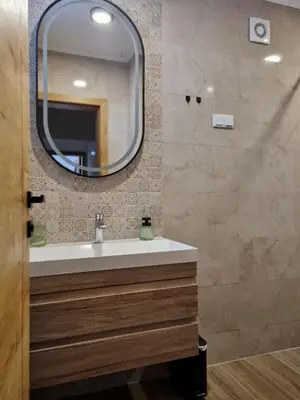 a bathroom with a sink and a mirror at Semic apartments in Visoko