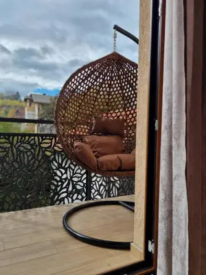 a wicker chair sitting on top of a balcony at Semic apartments in Visoko