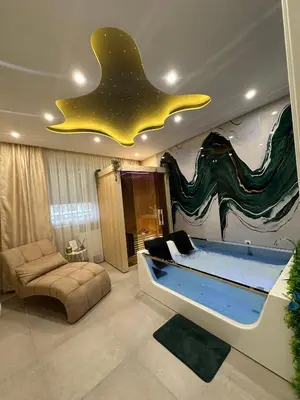 a room with a large bed with a star on the ceiling at Spa Apartman Love&Spa in Železnička Stanica Banja Luka Predgrađe