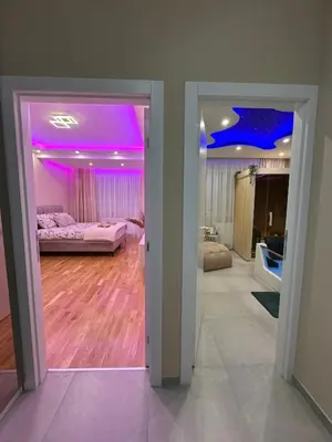 a room with two beds and a purple ceiling at Spa Apartman Love&Spa in Železnička Stanica Banja Luka Predgrađe
