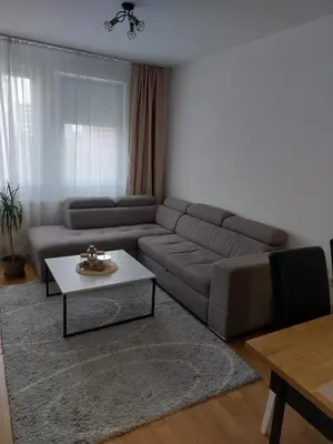 a living room with a couch and a table at Moonlight Apartment in Banja Luka