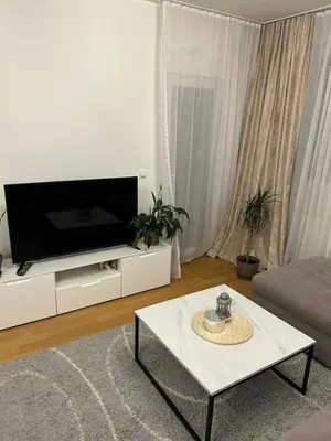 a living room with a tv and a table at Moonlight Apartment in Banja Luka