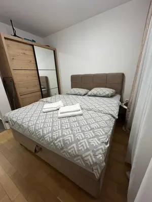 a bedroom with a bed with two towels on it at Moonlight Apartment in Banja Luka