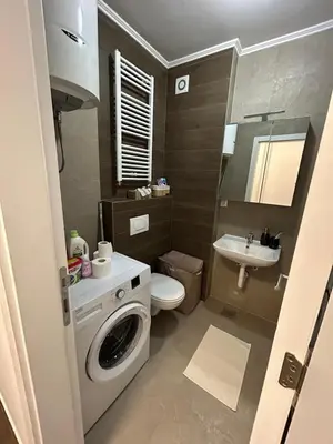a bathroom with a washing machine and a sink at Moonlight Apartment in Banja Luka
