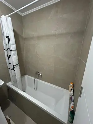 a bathroom with a bath tub with a sink at Moonlight Apartment in Banja Luka