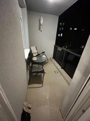 a hallway with a table and a chair in a room at Moonlight Apartment in Banja Luka