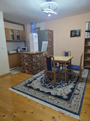 a kitchen and dining room with a table and chairs at Vila Emani in Visoko