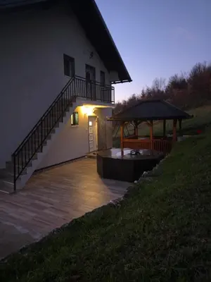 a house with a staircase and a gazebo at night at Vila Emani in Visoko