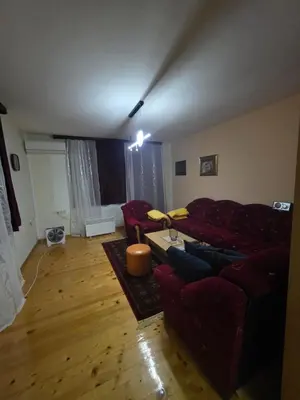 a living room with a red couch and a table at Vila Emani in Visoko