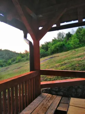 a porch of a cabin with a view of a field at Vila Emani in Visoko