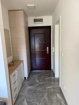 a hallway with a brown door in a room at Kutak mira in Doboj