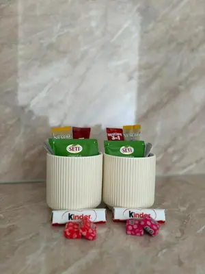 two packages of food sitting on a table with bows at Kutak mira in Doboj